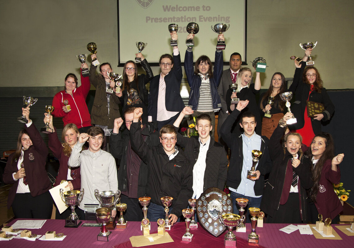 Image of Former Y11 students celebrate their achievements at Presentation Evening